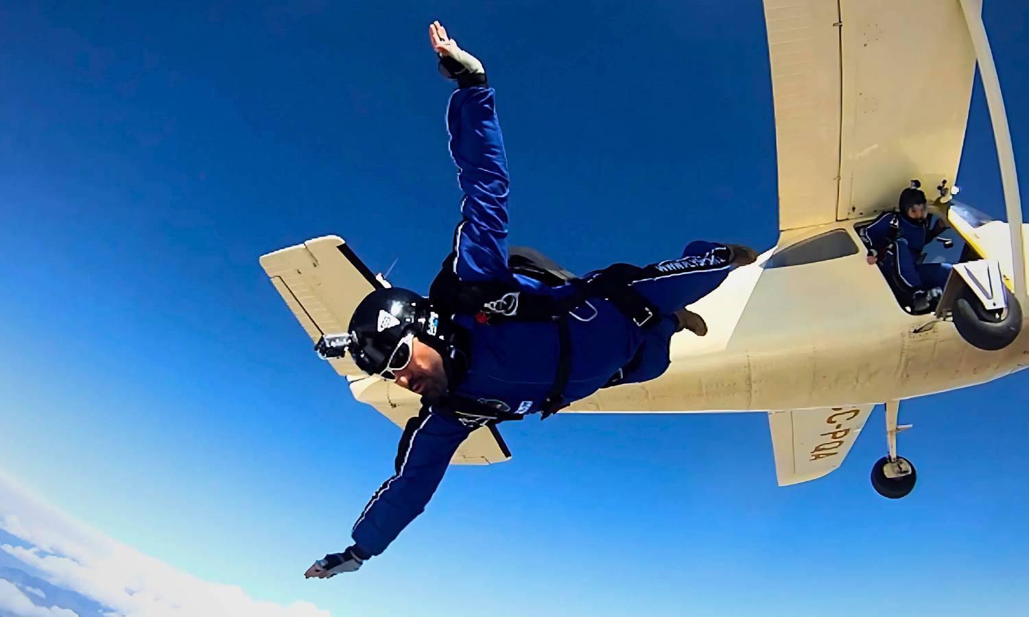 Imagen de un paracaidista flysport saltando del avion con los brazos abiertos